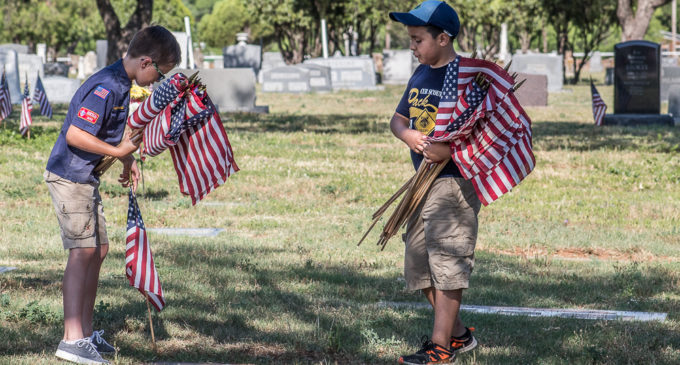 Honoring the fallen: Local Cub Scouts place flags on veterans’ graves