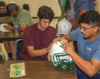 Buckaroos decorate team helmets with dads as they gear up for Jacksboro tonight