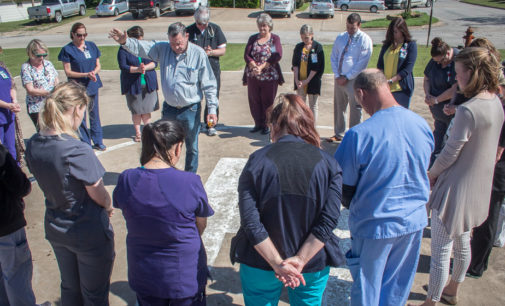 SMH staff gathers for prayer circle on helicopter landing pad
