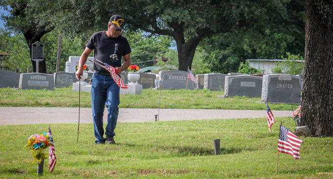 Volunteers help place flags on veterans’ graves; Memorial Day ceremony scheduled for 10 a.m. today