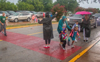 Rain, umbrellas and first day of school in photos