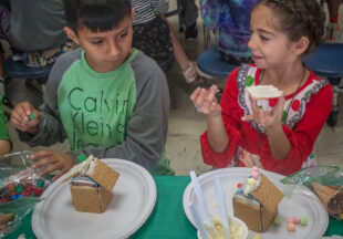 Second-graders decorate gingerbread houses