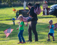 Community honors veterans with flags at cemetery; Memorial Day service to be held at courthouse this morning