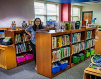 New East Elementary library paraprofessional working on creating a welcoming, comforting environment for students