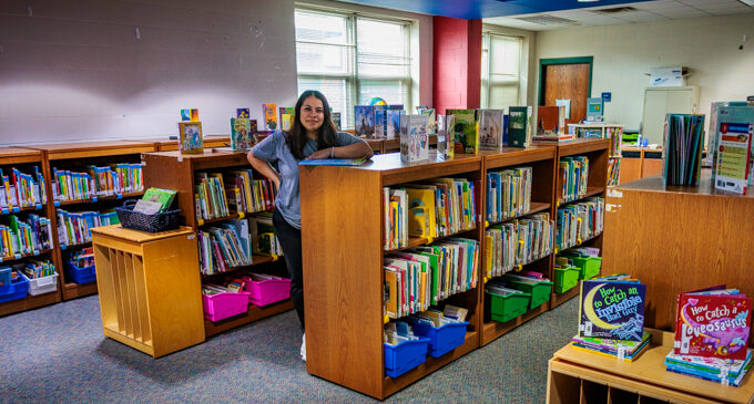 New East Elementary library paraprofessional working on creating a welcoming, comforting environment for students